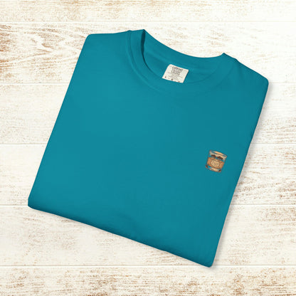 Folded Rodeo On The Rocks Tee in teal, made from soft 100% US cotton, featuring a subtle graphic on the chest, great for relaxed wear.