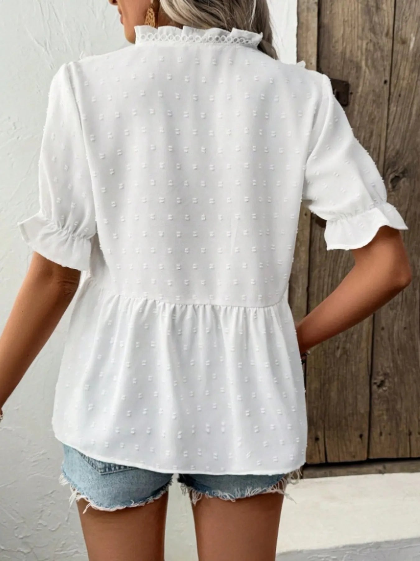 Back view of the Swiss Dot Ruffled V-Neck Blouse with Flounce Sleeves, showcasing its frill design and lightweight fabric, perfect for casual summer outfits.