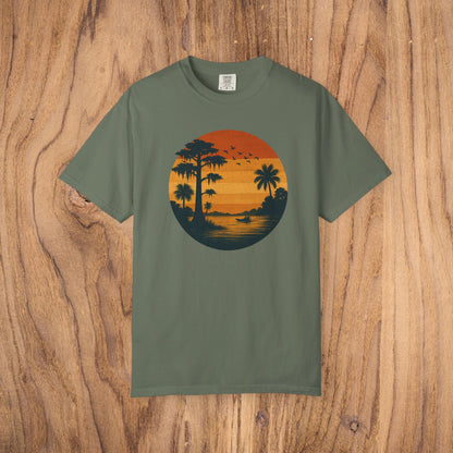 Unisex Garment-Dyed Sunset Tee in olive green featuring a vintage sunset design with palm trees, perfect for casual wear and available in sizes S to 4XL.