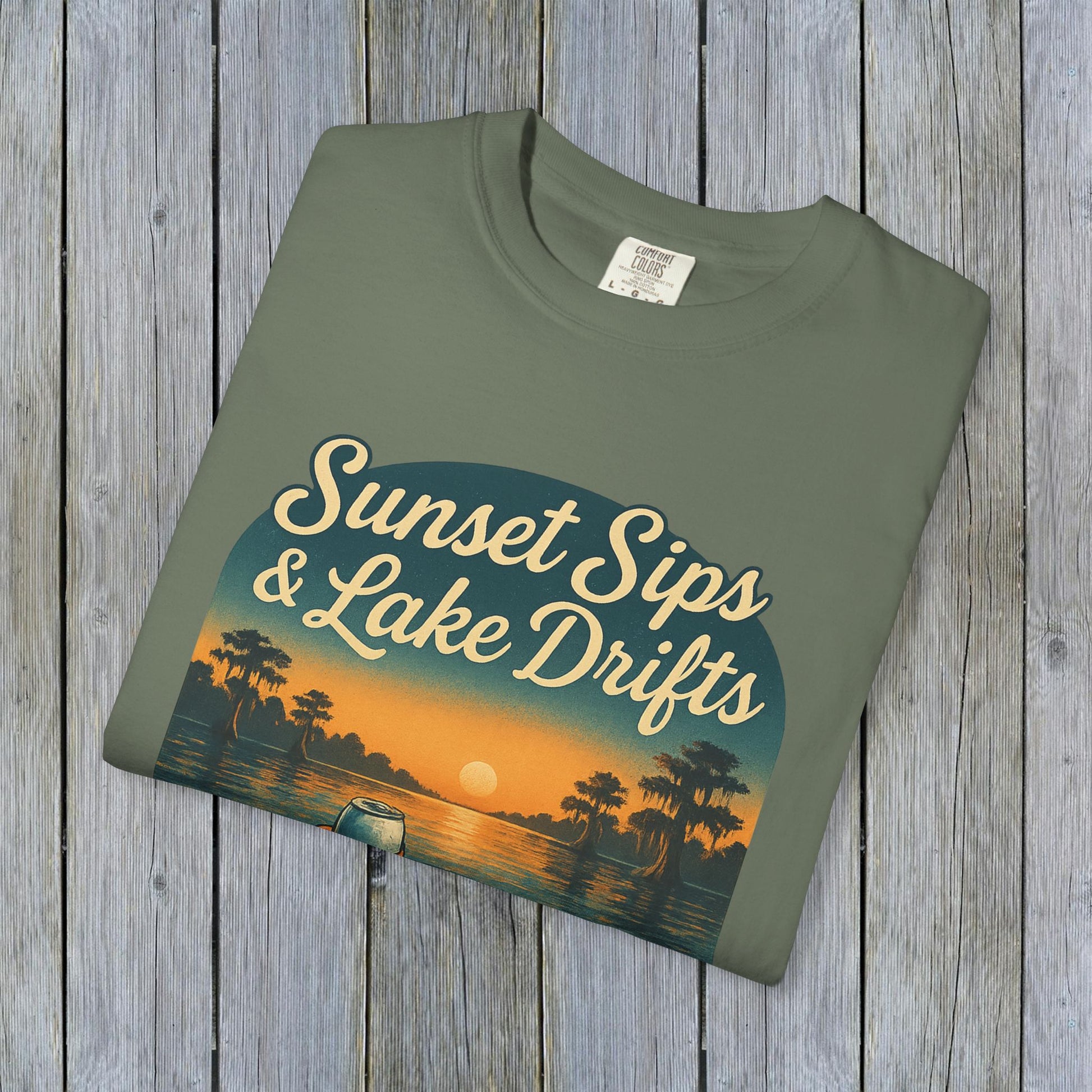 Lake Drifts T-Shirt featuring sunset design in olive green color, highlighting soft 100% US cotton fabric with unique colors.