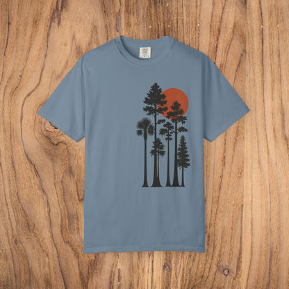 Sunset Trees Unisex T-Shirt in light blue, showcasing a peaceful tree silhouette with a red sun, crafted from 100% cotton for ultimate comfort and style.