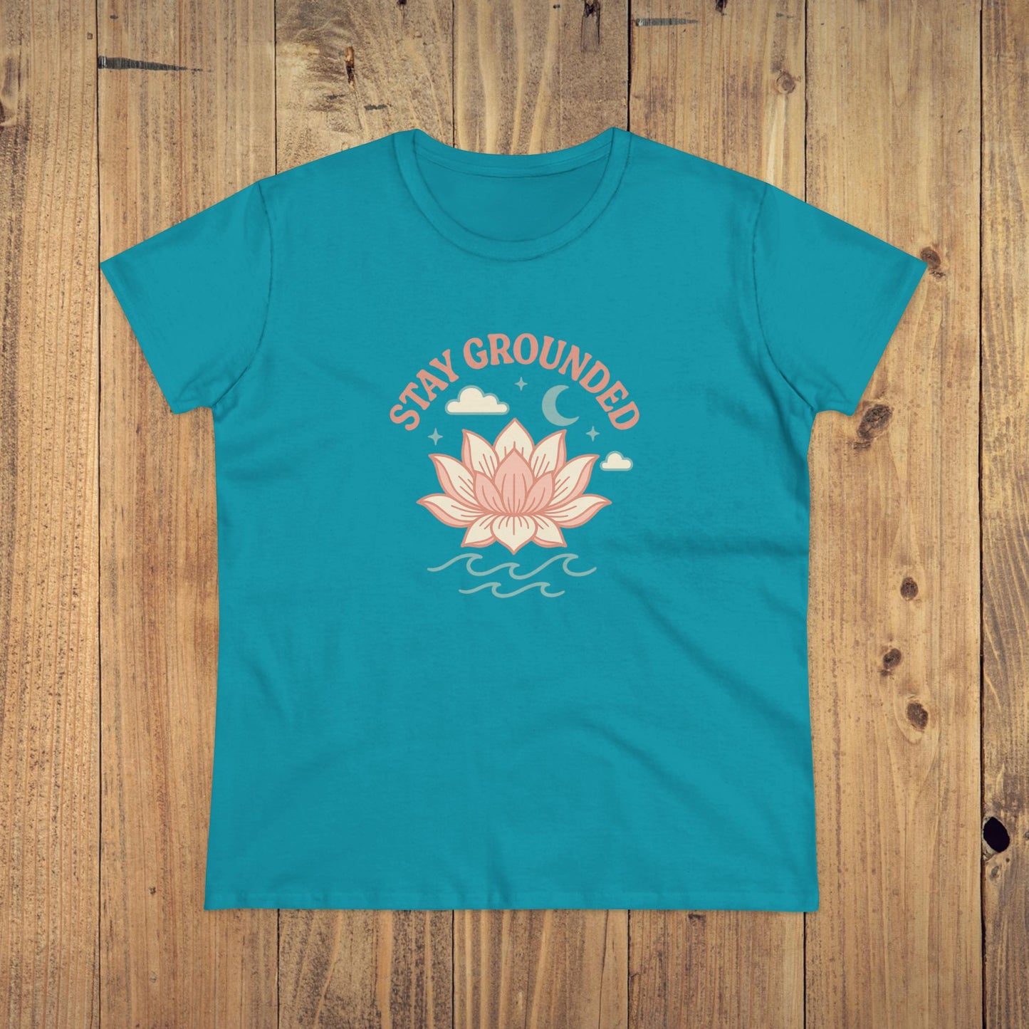 Stay Grounded Spiritual Tee in turquoise displaying a charming lotus flower design, perfect for beach days and festival fun.