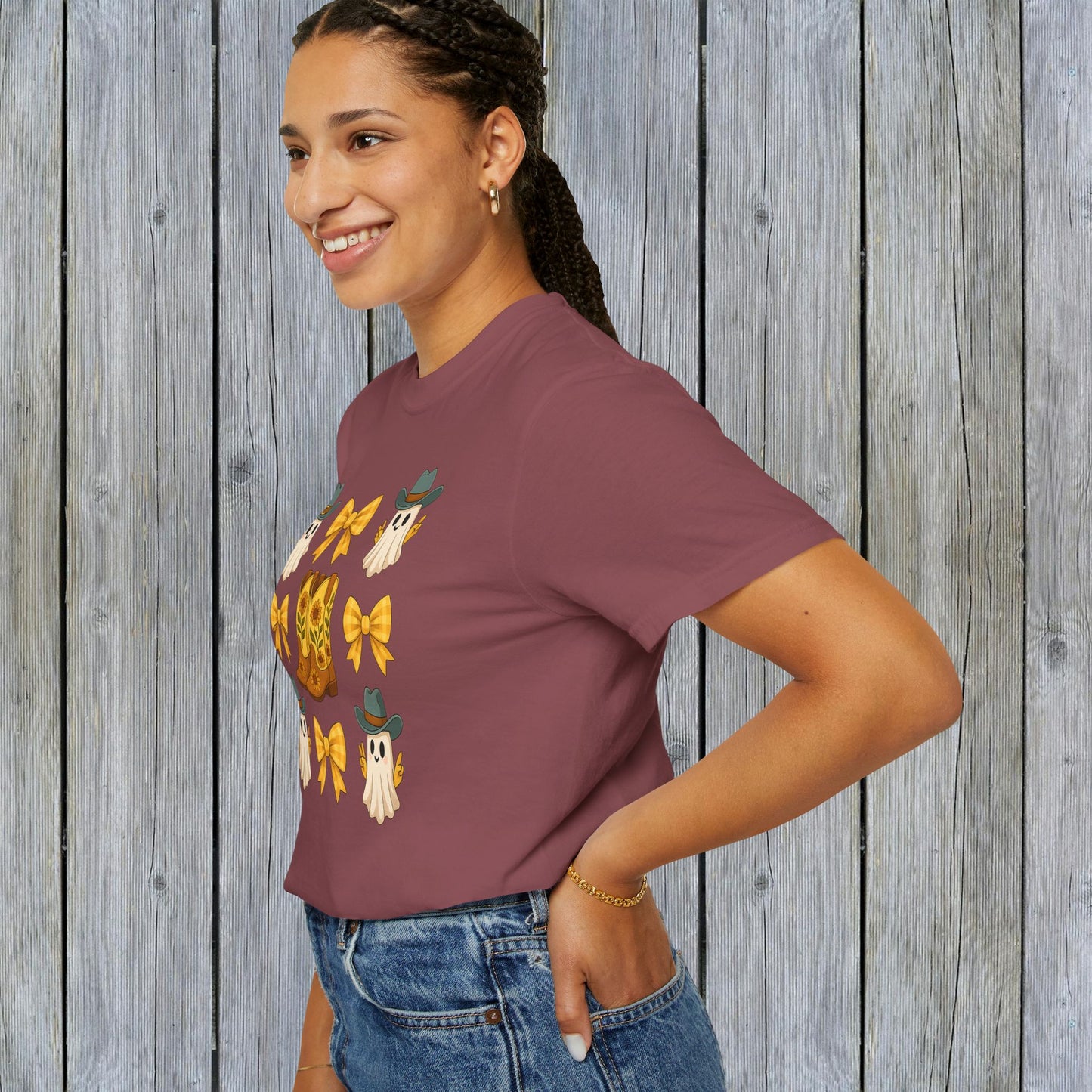 Model showcasing a Cute Halloween T-Shirt with a playful ghost and cowboy boot design. Ideal for stylish unisex fall fashion, crafted from eco-friendly fabric.