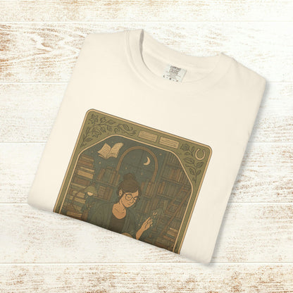 Page Turner Tarot Tee in cream, featuring a mystical design of a woman engaging with books, ensuring comfort and sustainability with eco-friendly cotton.