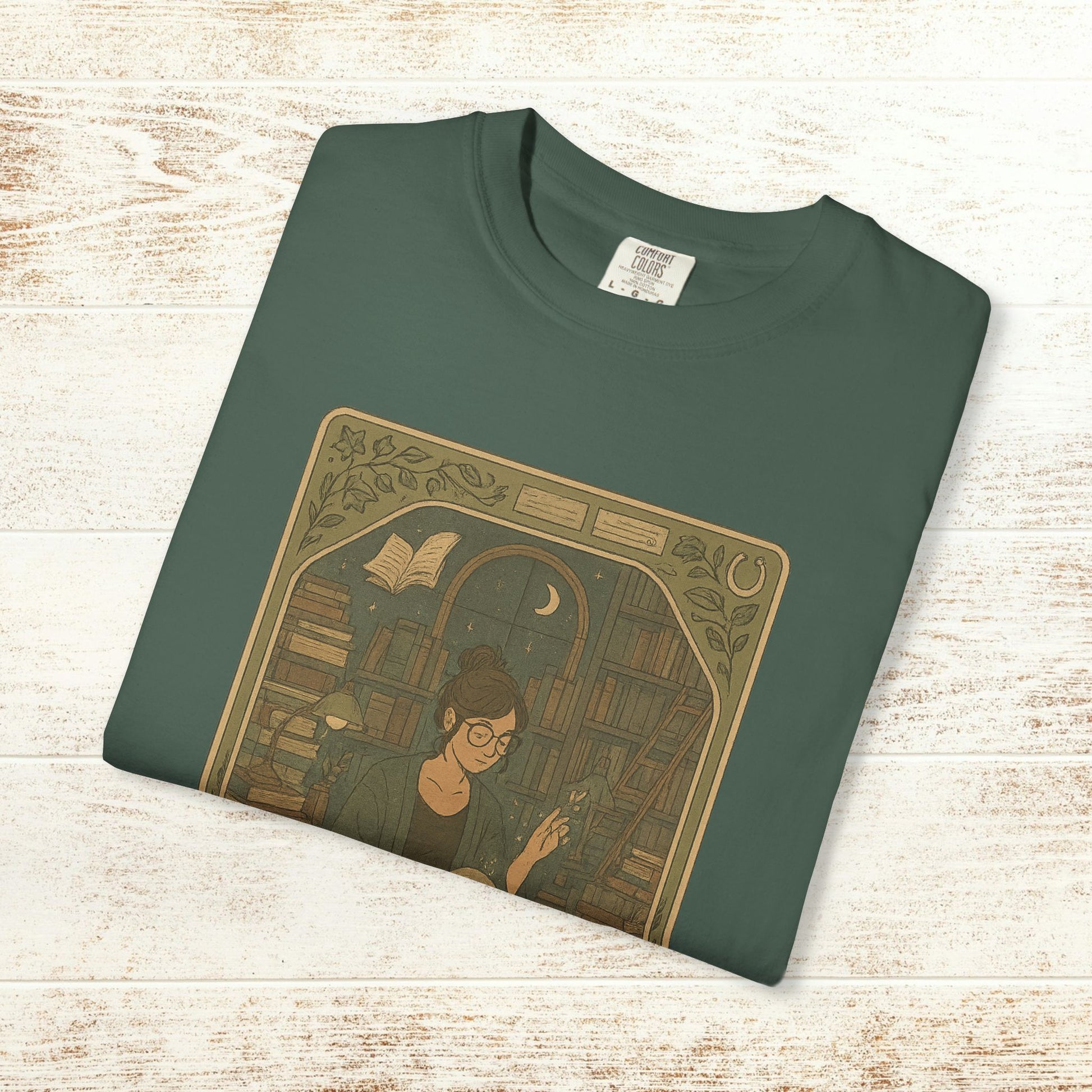 Page Turner Tarot Tee in green, stylish soft cotton t-shirt showcasing an illustration of a woman with books, available in sizes S to 4XL, eco-friendly and comfortable.