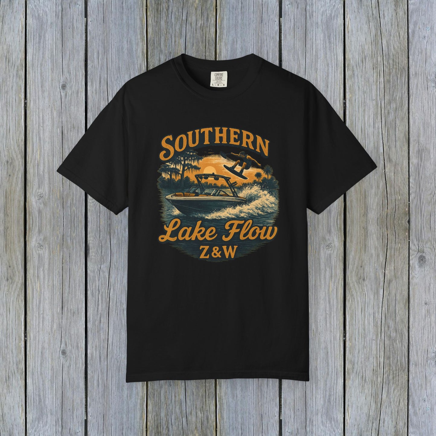 Southern Lake Flow T-Shirt in black, displaying a dynamic graphic of a person skiing on water, crafted from eco-friendly 100% US cotton, offered in sizes S-4XL.