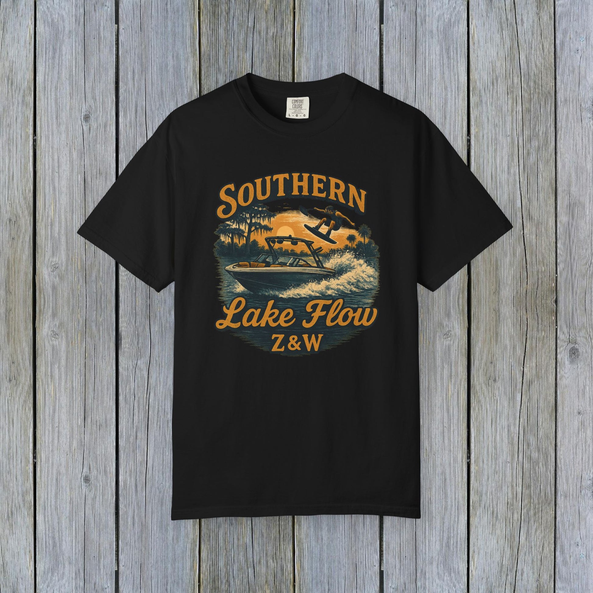 Southern Lake Flow T-Shirt in black, displaying a dynamic graphic of a person skiing on water, crafted from eco-friendly 100% US cotton, offered in sizes S-4XL.