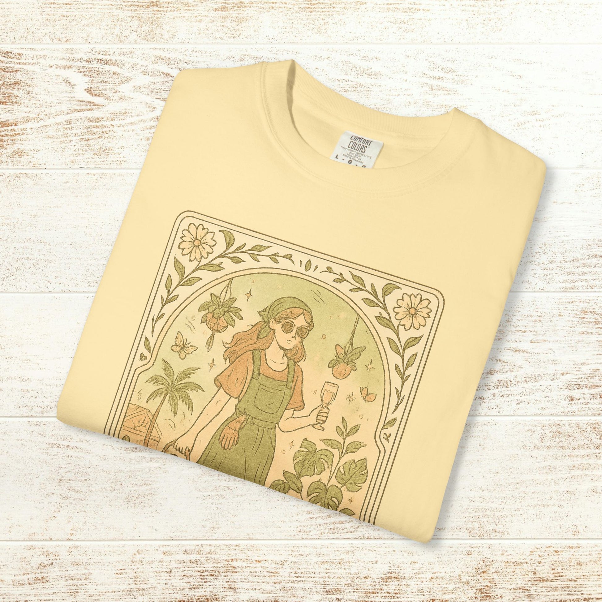 Rooted One Tarot Tee in light yellow, highlighting an artistic illustration of a girl with sunglasses amid plants and butterflies, made from ethically sourced cotton, available in sizes S-4XL.