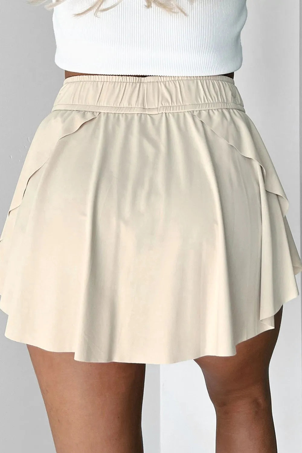 Back view of Drawstring High Waist Lined Active Skorts featuring a flared design and comfortable waistband.