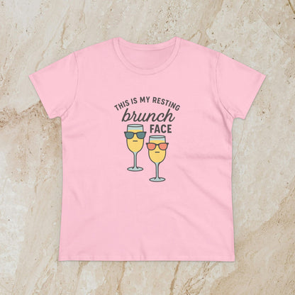 Women's Premium 100% Cotton Brunch Face Tee in light pink with a whimsical print of two cocktails with sunglasses stating 'THIS IS MY RESTING brunch FACE'. The perfect tee for stylish brunch occasions.