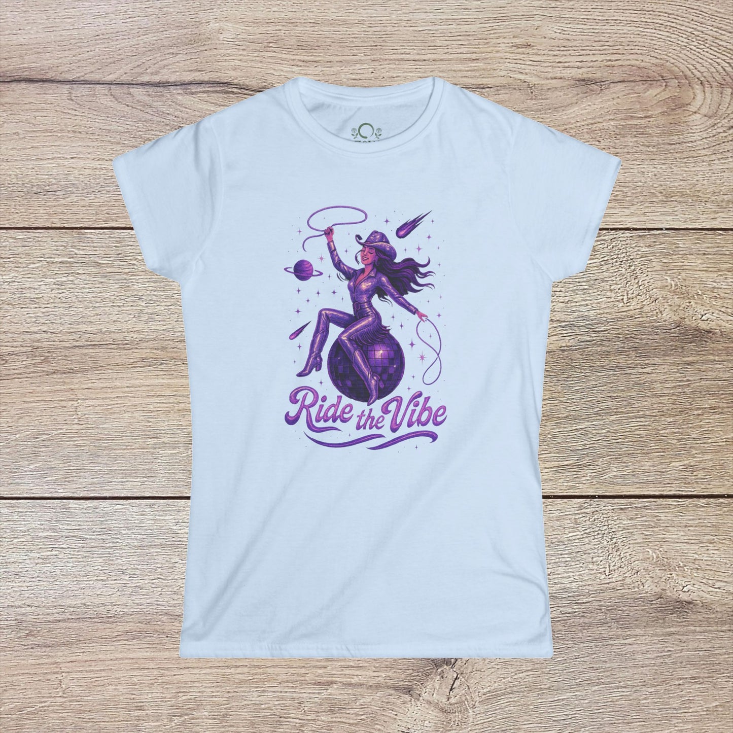 Vibrant Ride The Vibe Tee in light blue depicting an artistic design of a woman riding a planet, made from comfortable 100% ring-spun cotton.