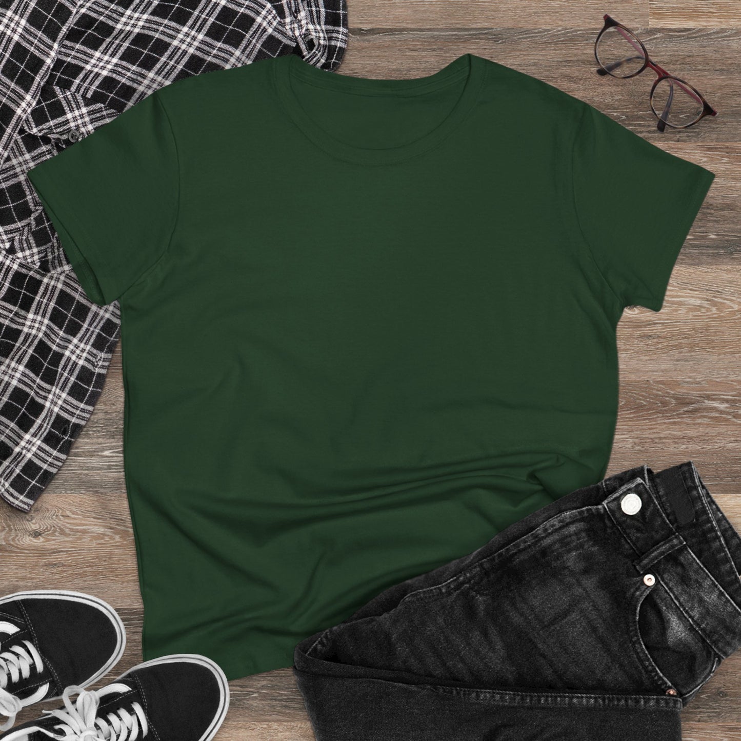 Casual styling of a green Unisex Dog Lover T-Shirt laid flat on a wooden surface with jeans and sneakers, emphasizing comfort and casual charm.