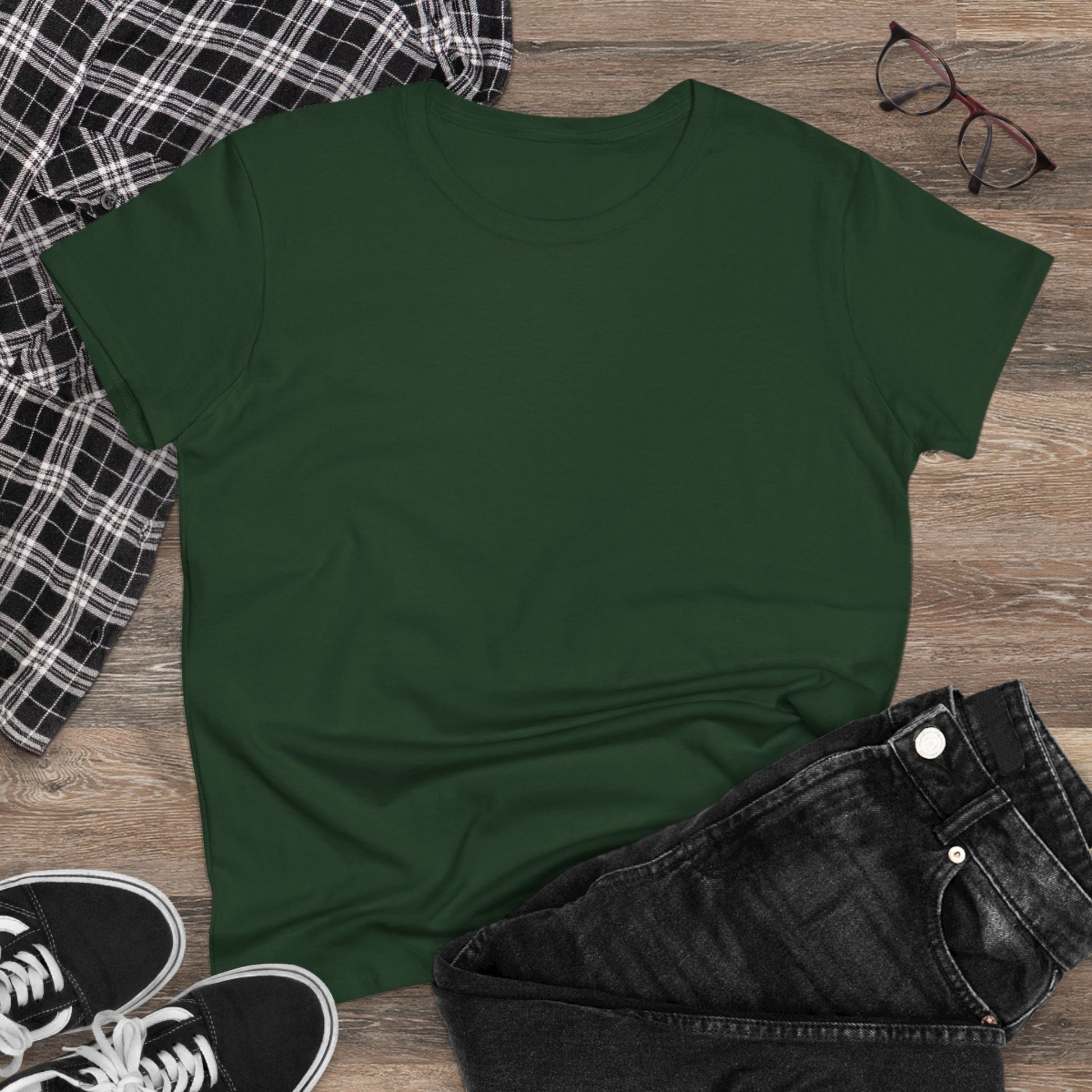 Casual styling of a green Unisex Dog Lover T-Shirt laid flat on a wooden surface with jeans and sneakers, emphasizing comfort and casual charm.