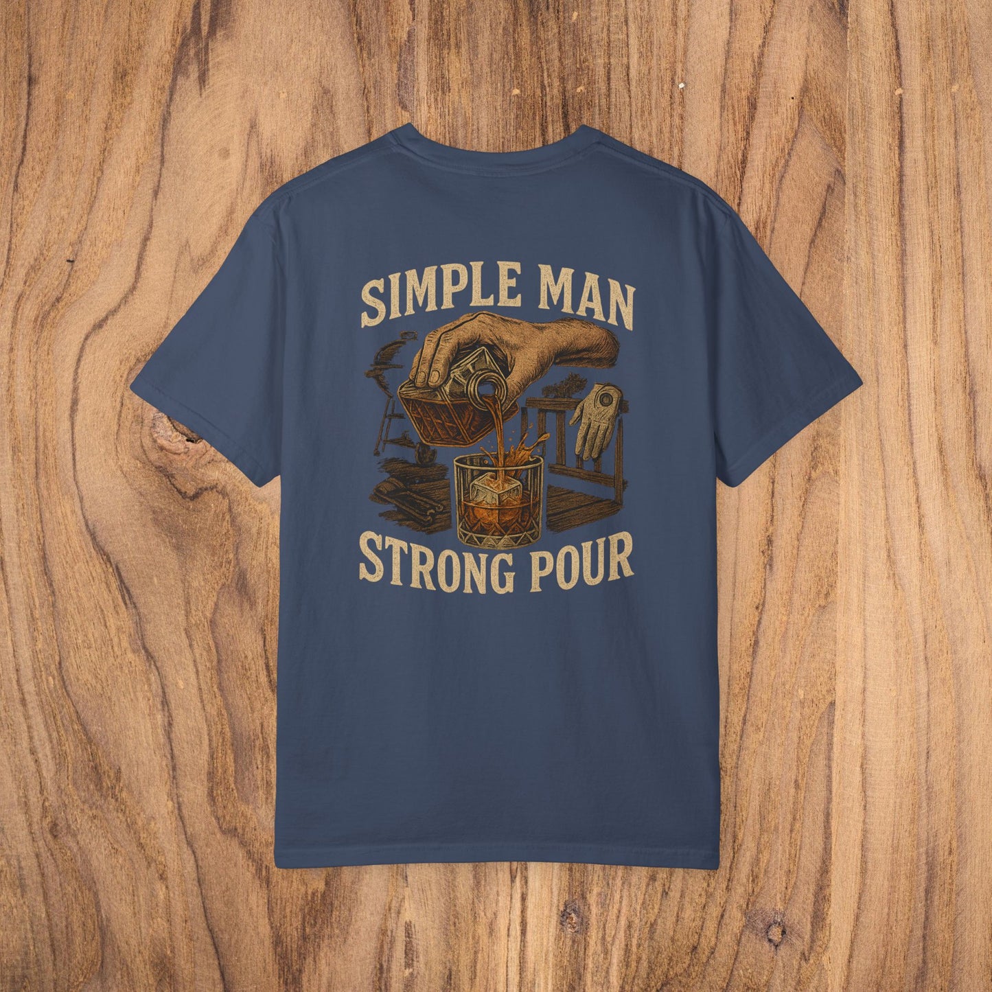 Simple Man Strong Pour T-Shirt in navy blue with an artistic illustration of a drink being poured, emphasizing classic fit and ethical material sourcing in 100% cotton for a soft feel.
