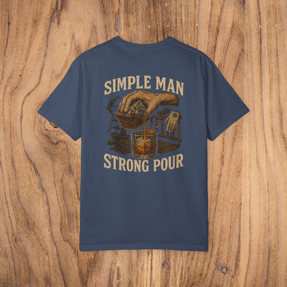 Simple Man Strong Pour T-Shirt in navy blue with an artistic illustration of a drink being poured, emphasizing classic fit and ethical material sourcing in 100% cotton for a soft feel.