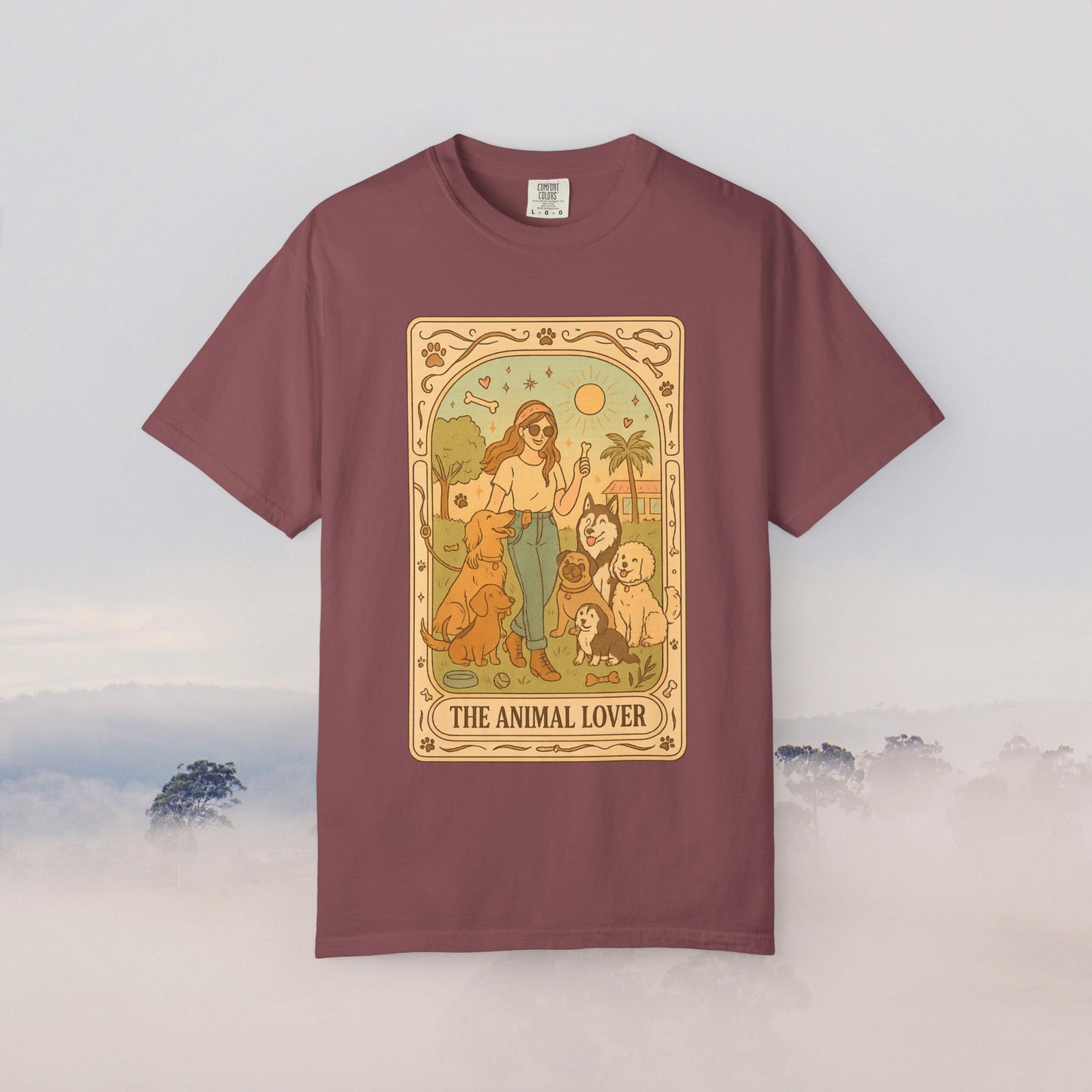 Animal Lover Tarot Tee in rich burgundy, showcasing a charming illustration of a woman with several pets, crafted from 100% cotton for all-day comfort.