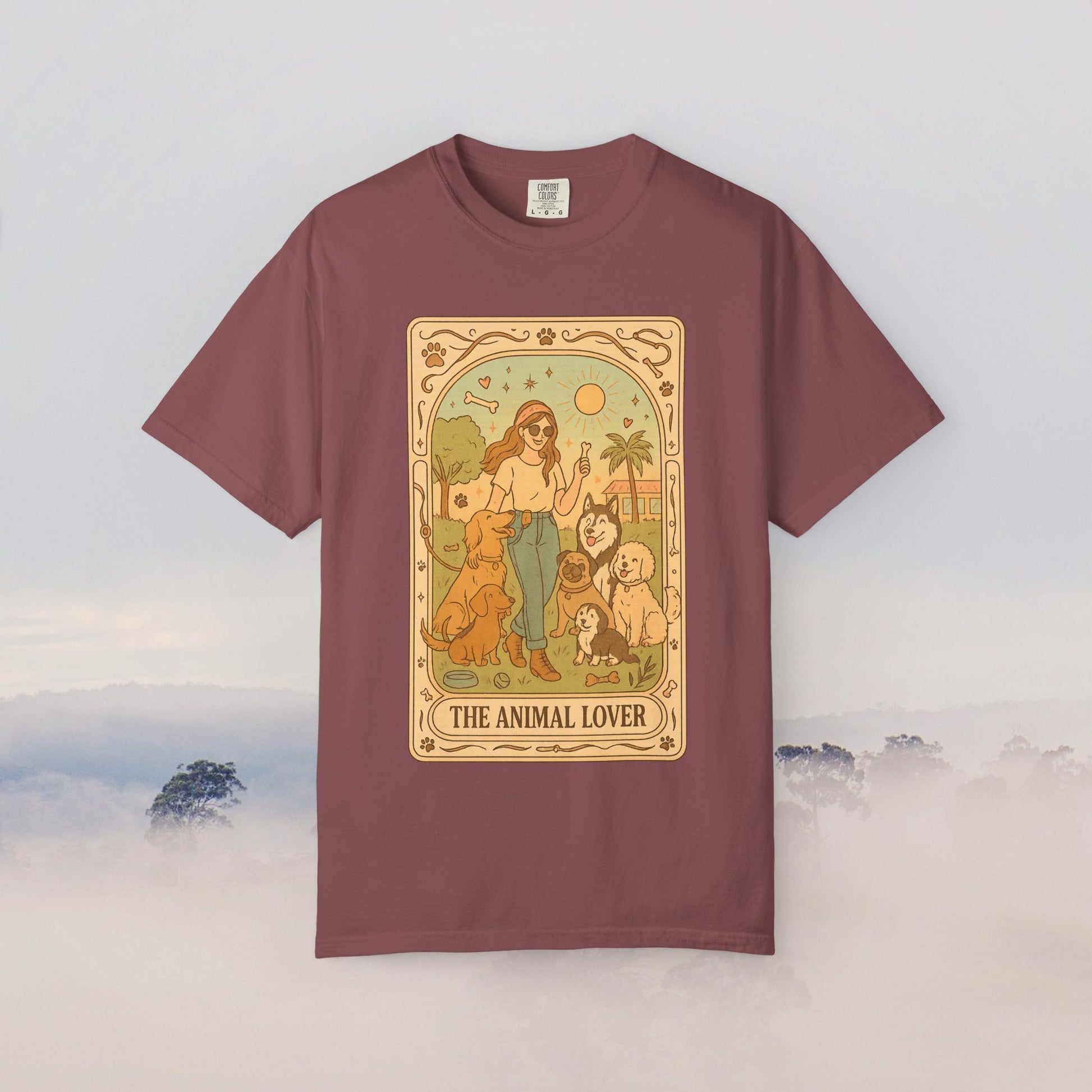 Animal Lover Tarot Tee in rich burgundy, showcasing a charming illustration of a woman with several pets, crafted from 100% cotton for all-day comfort.