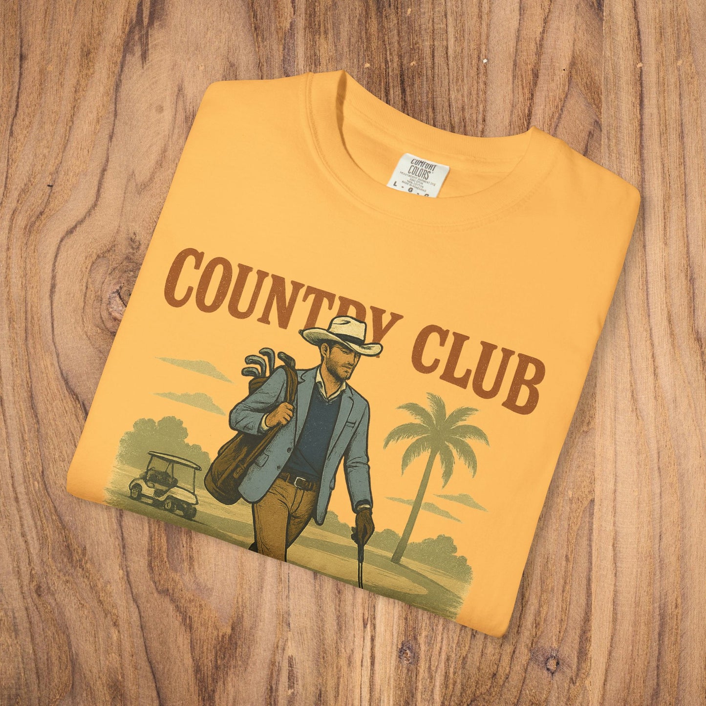 Country Club Cowboy Graphic Tee in a vibrant yellow color, showcasing a stylish man with golf clubs and a relaxed vibe, ideal for golf lovers.