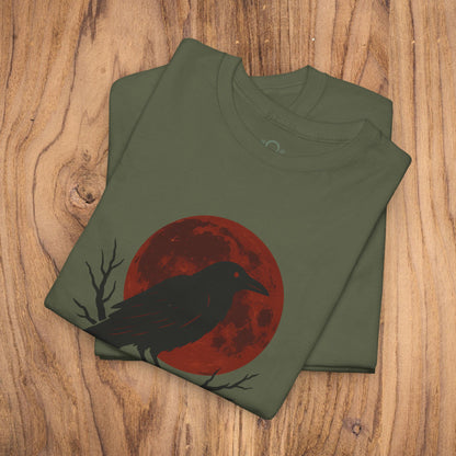 Gothic Raven T-Shirt displaying a raven against a vibrant red moon, ideal for Halloween attire. Crafted with heavy cotton, this unique spooky gift fits perfectly into casual fall fashion.