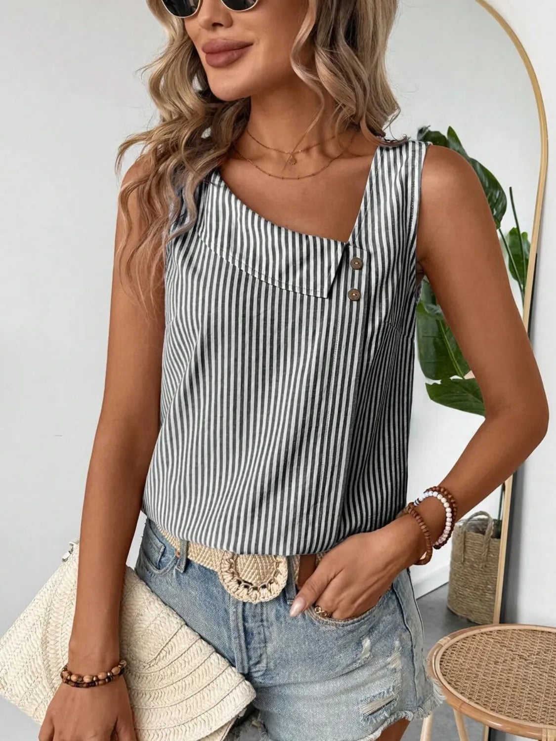 Stylish Asymmetrical Striped Tank with Decorative Buttons for Women, showcasing a fashionable design in a casual setting, made of 100% polyester.