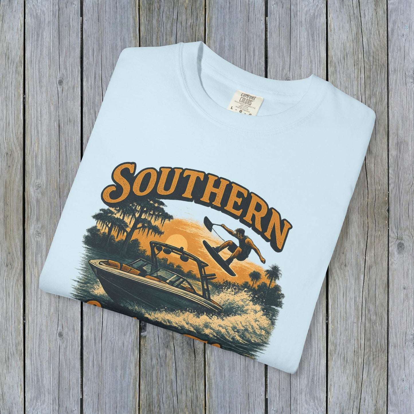 Folded Southern Lake Flow T-Shirt in light mint, highlighting the retro wakeboarding graphic, showcasing sustainable fashion made from 100% US cotton.