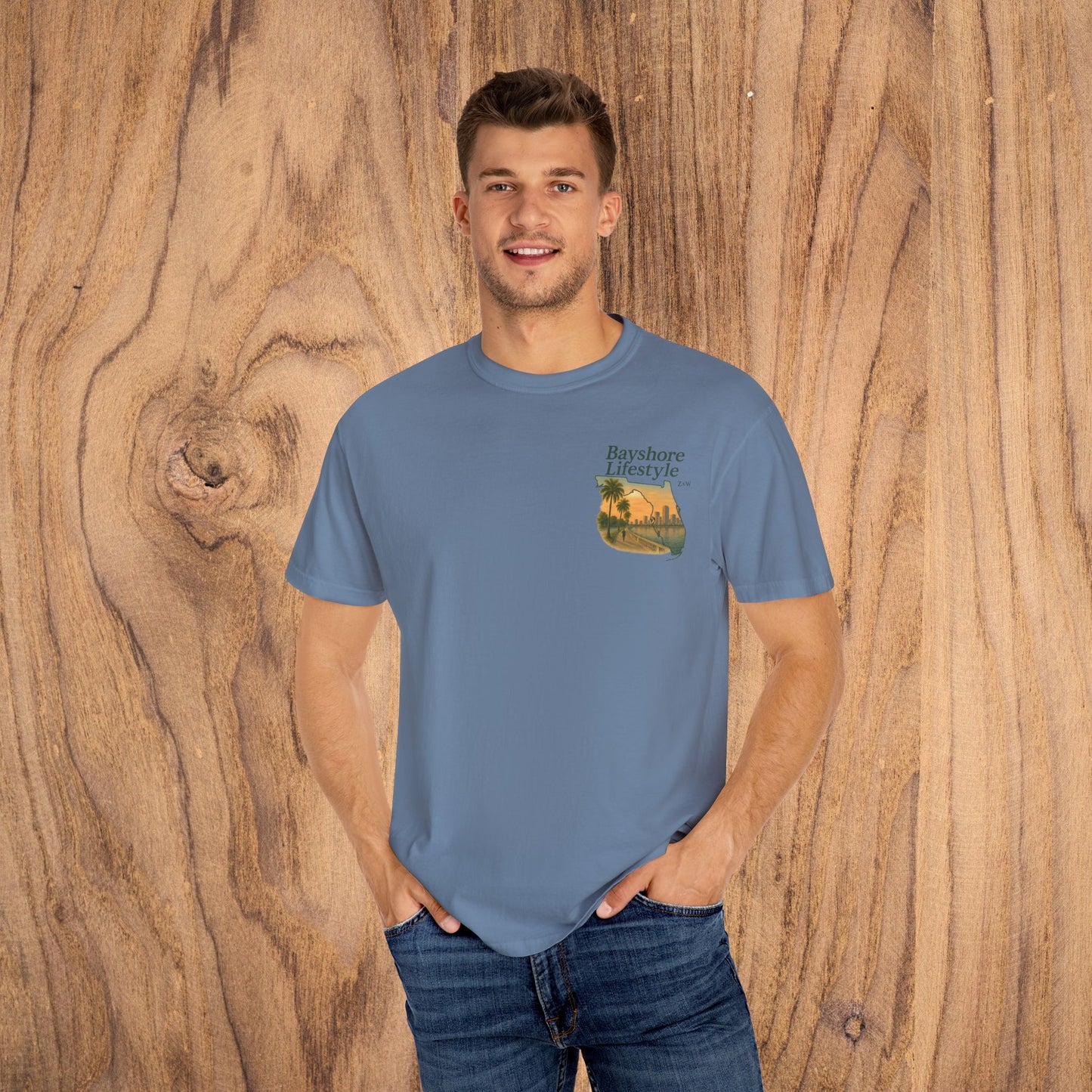 Stylish man wearing a Bayshore Lifestyle Tee in blue, showcasing the 100% cotton lightweight fabric and ribbed neck.