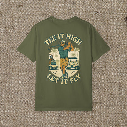 Tee It High Let It Fly Graphic Tee showcasing a golfer in action with a tropical background, perfect for golf enthusiasts.