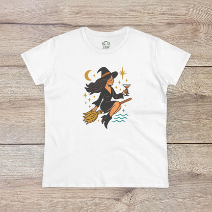 Witchy Night Out Tee featuring a stylish illustration of a witch flying on a broomstick with an hourglass, set against a cosmic backdrop, made from 100% cotton and ethically produced.