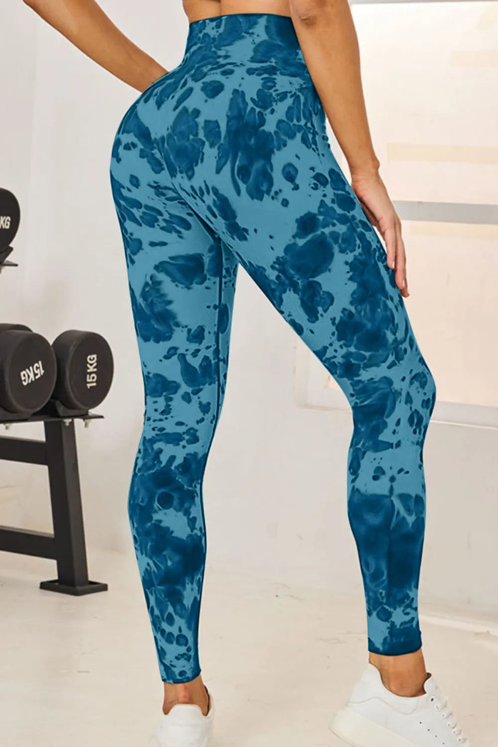 Slightly Stretchy Tie-Dye High Waist Active Leggings in blue, showcasing a side view with a fitness environment in the background.