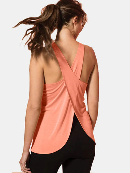 Model wearing Crisscross Scoop Neck Tank Top for Active Wear in coral, highlighting the fashionable crisscross back suitable for gym sessions.