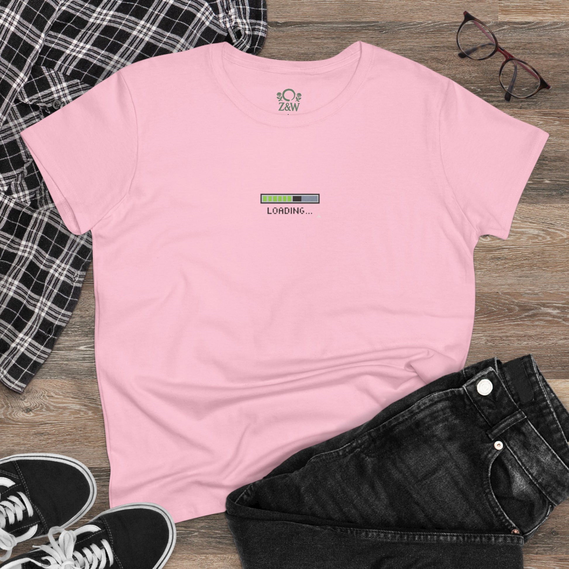 404 Y2K Graphic T-Shirt in light pink, styled on a flat surface with jeans and sneakers, featuring a whimsical 'loading...' design perfect for casual outings.