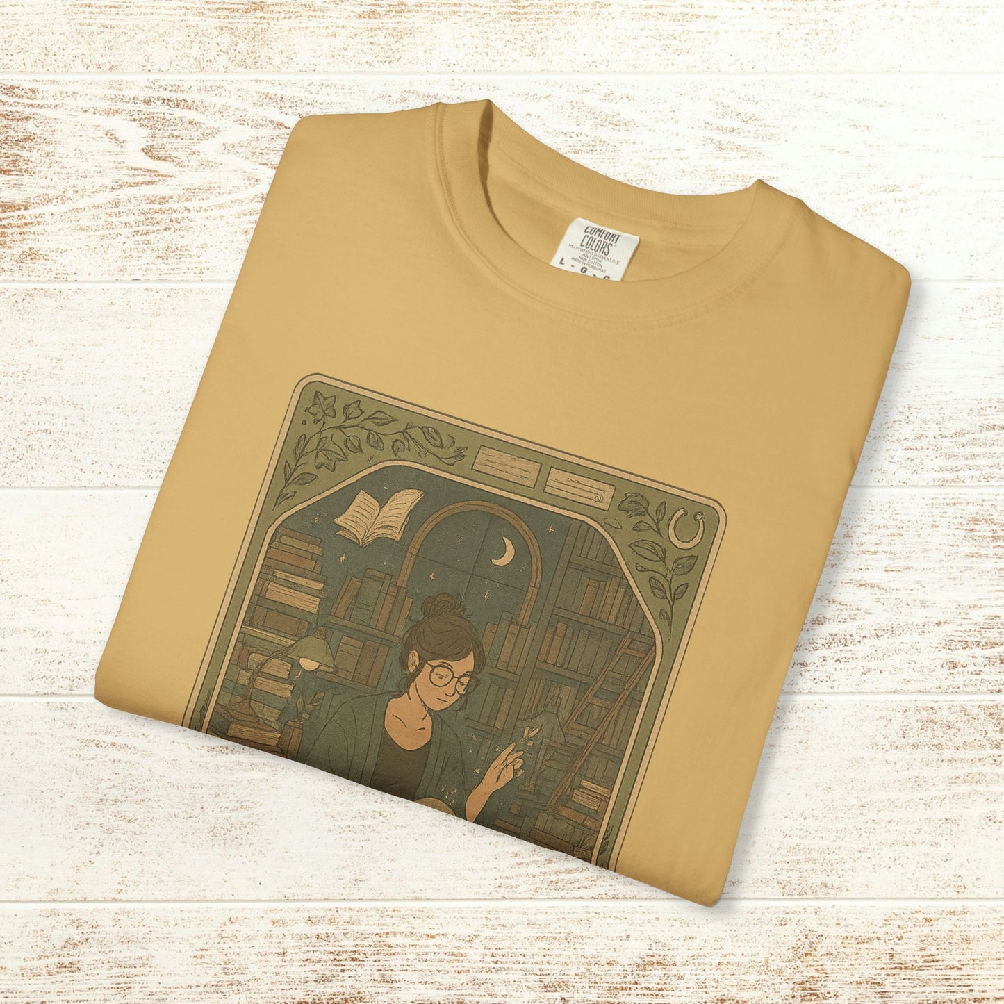 Page Turner Tarot Tee in mustard color depicting a whimsical illustration of a woman among books, crafted from soft cotton, sizes S to 4XL, eco-friendly and comfortable.
