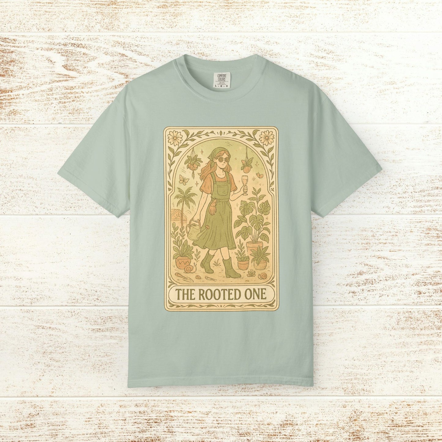 Rooted One Tarot Tee in mint color, highlighting a striking tarot-inspired illustration of a woman surrounded by plants, made from ethically sourced cotton.