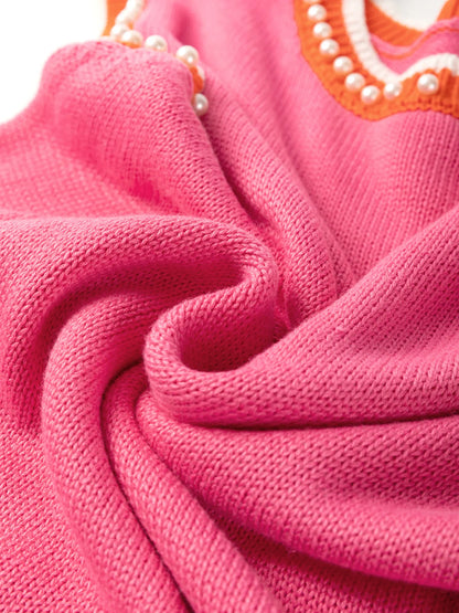 Attention to detail in the Stylish Contrast Trim Pearl Detail Sweater Tank Top, highlighting the soft pink fabric and stylish pearl embellishments.