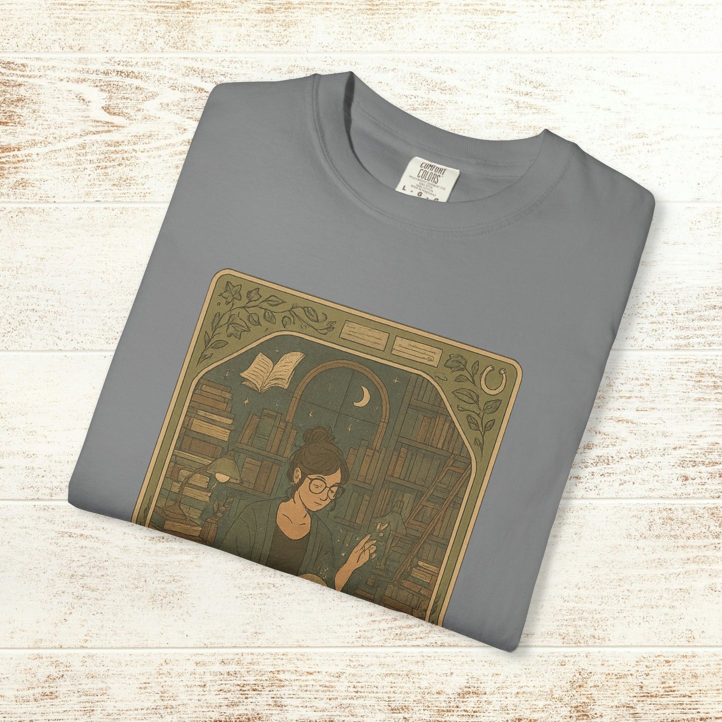 Page Turner Tarot Tee in grey, high-quality soft cotton t-shirt with a captivating design of a woman reading, available in sizes S to 4XL, eco-friendly and comfortable.