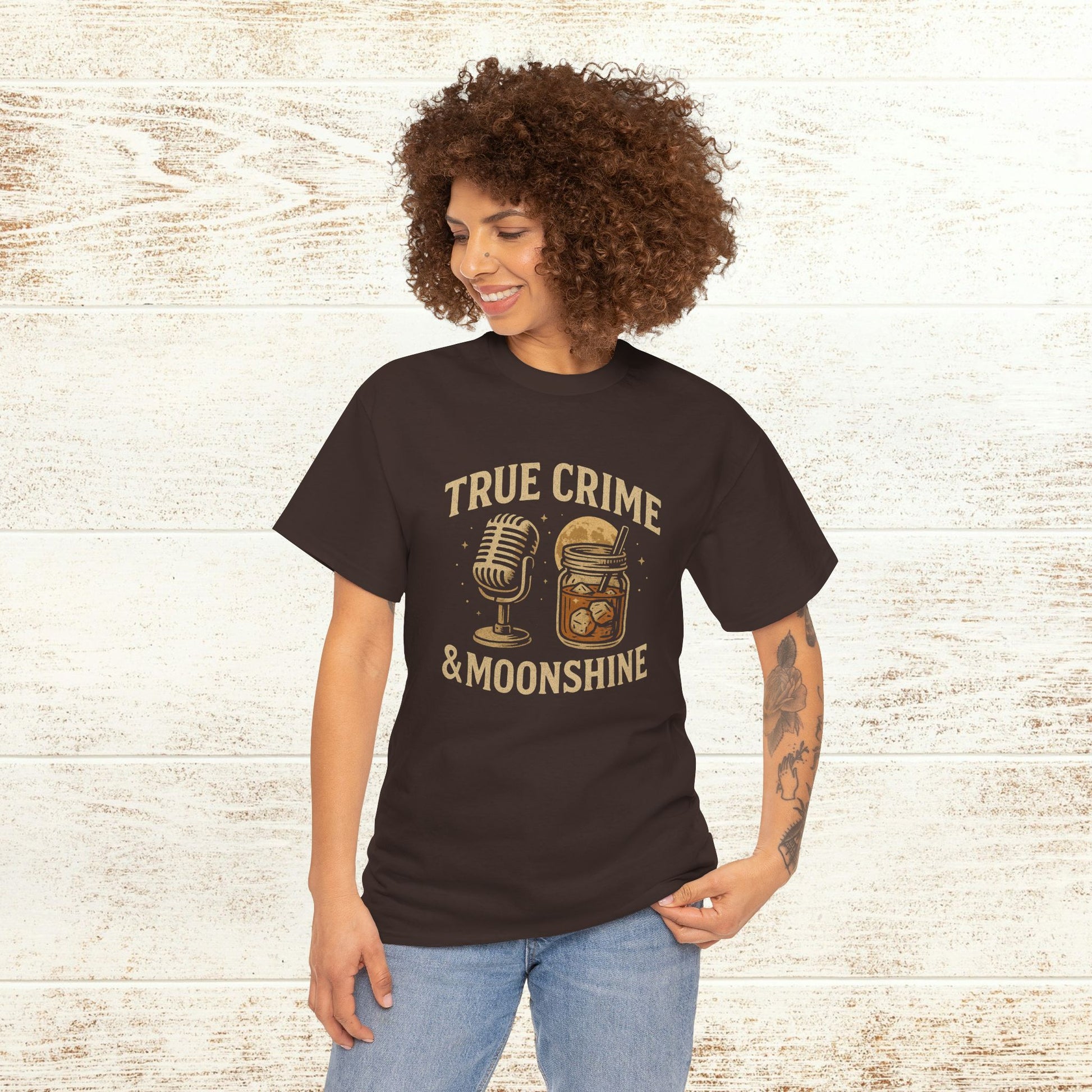 Model wearing the True Crime & Moonshine Unisex Graphic Tee with vibrant graphics, perfect for showcasing personal style at social gatherings.