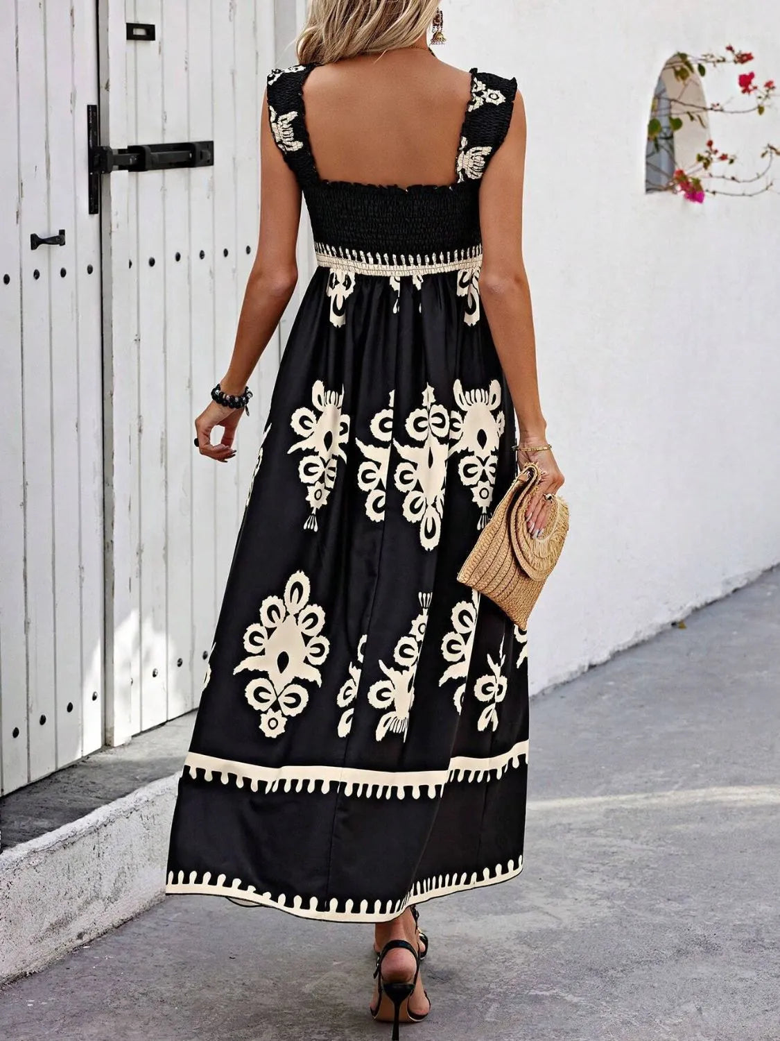 Back view of the Trendsi Smocked Printed Maxi Dress with Wide Straps, demonstrating the intricate design and elegant finish on a model in an outdoor space.