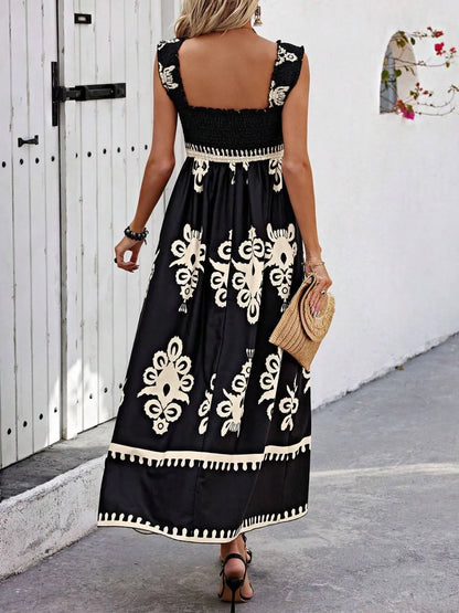 Back view of the Trendsi Smocked Printed Maxi Dress with Wide Straps, demonstrating the intricate design and elegant finish on a model in an outdoor space.