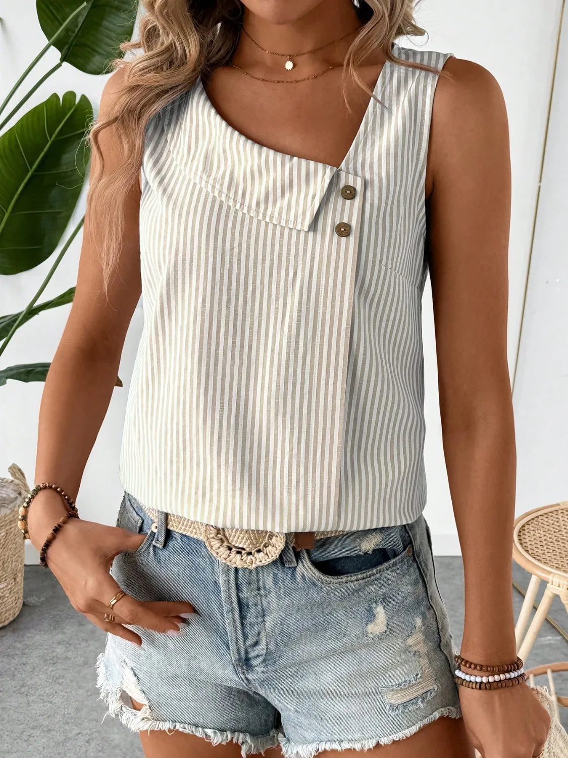 Front view of the Asymmetrical Striped Tank with Decorative Buttons for Women in a cream striped style, highlighting trendy design details suitable for everyday wear.