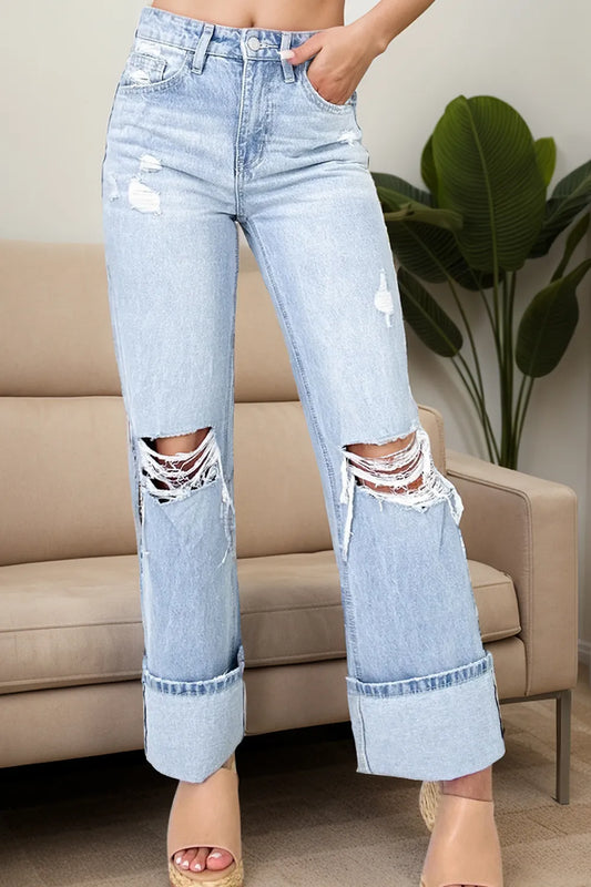Trendy Distressed High Waist Jeans with Pockets - Slightly Stretchy Comfort Fit showcased in a modern living room setting. The jeans feature a distressed look and a fashionable high waist design, ideal for casual and trendy outfits.