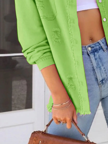 Model holding a handbag while wearing an Oversized Distressed Denim Jacket with Frayed Edges and Buttoned Pockets - Trendy Casual Outerwear, featuring a stylish casual look.