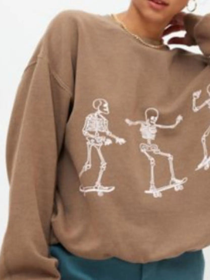 Close-up of the Oversized Skeleton Graphic Sweatshirt for Women, highlighting the fun skeleton motifs, made from 100% polyester for a comfortable and slightly stretchy wear.
