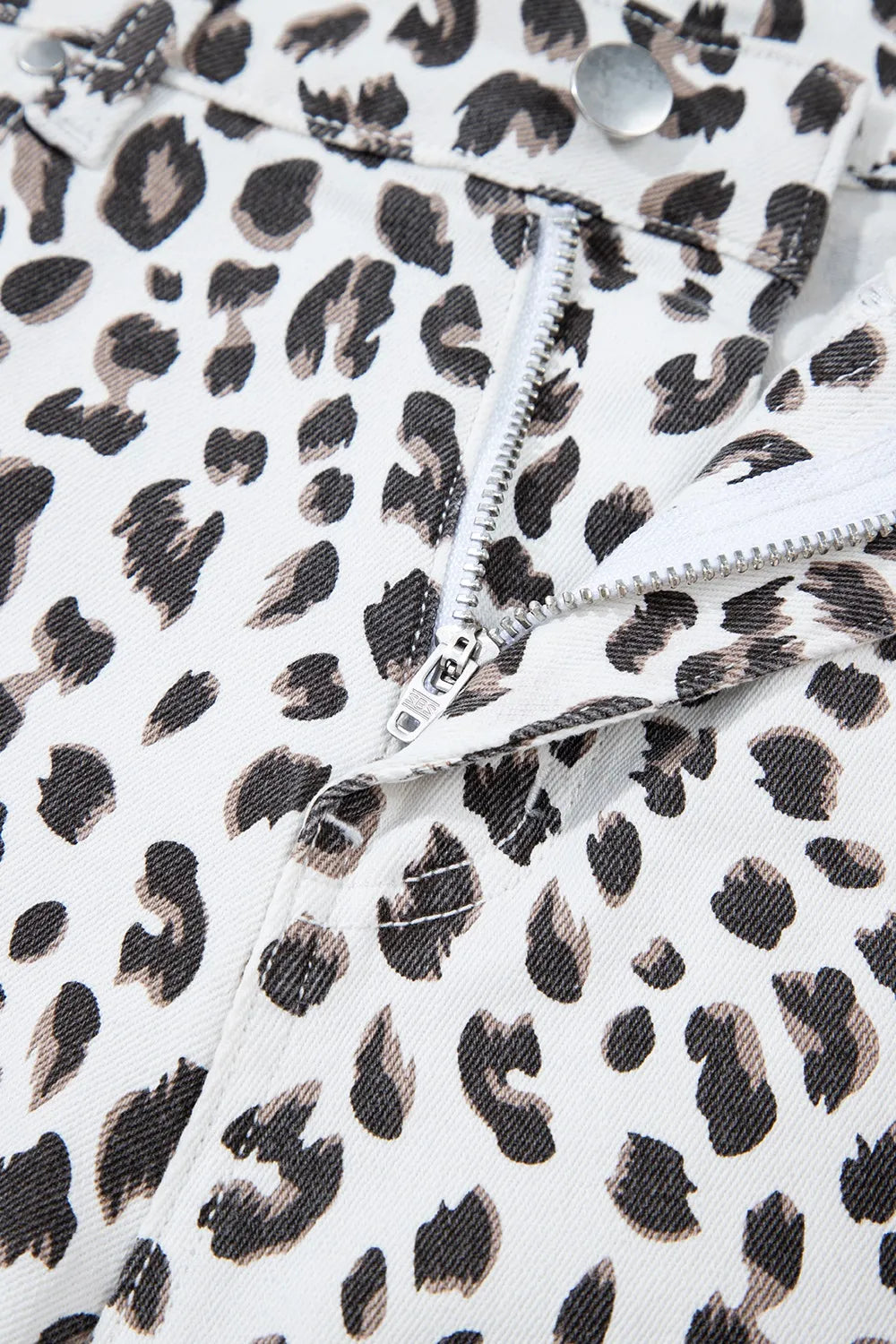 Zipper and closure detail of Leopard Frayed Hem Denim Shorts - Focus on the stylish leopard fabric and secure fastening.