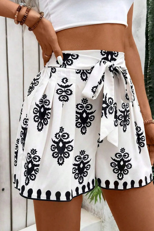 Trendy Tied Printed Shorts with a chic design and comfortable fit, showcasing a black and white print. A must-have addition for a fashionable summer wardrobe.