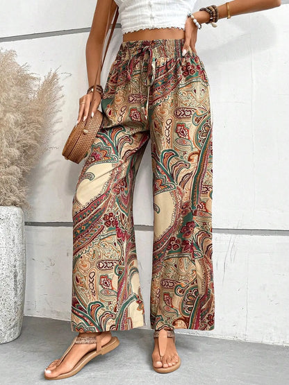 Trendy Printed Wide Leg Pants with Tied Detail showcased in a side view, featuring a vibrant paisley pattern and 100% opaque polyester fabric, ideal for casual outings or summer events.
