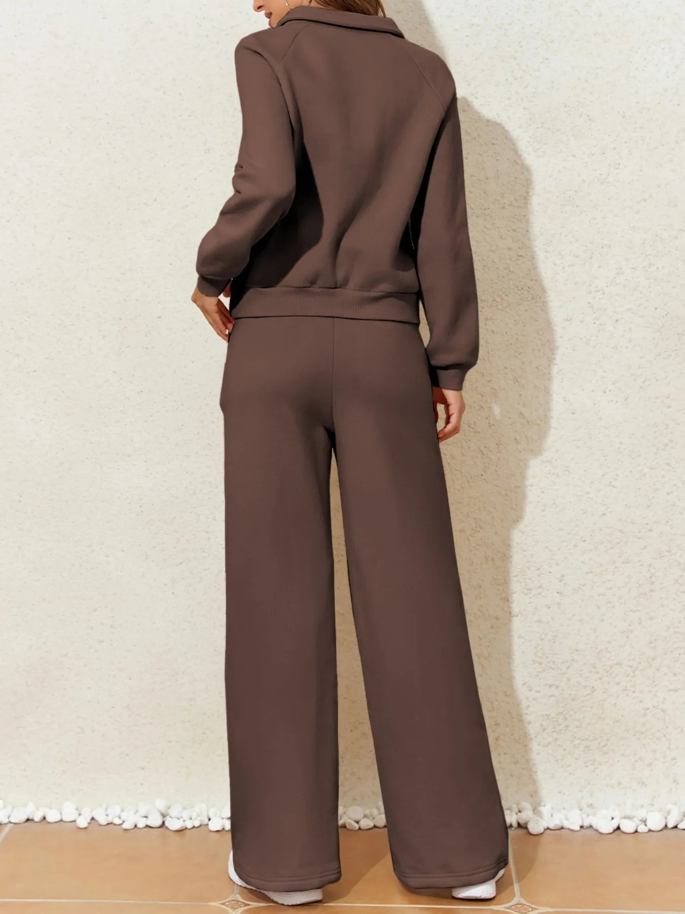 Back view of the model in the Trendsi Collared Sweatshirt & High Waist Pants Two-Piece Active Set in brown.