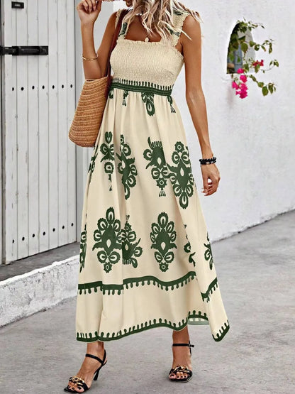 Trendsi Smocked Printed Maxi Dress with Wide Straps - Elegant Opaque, Non-Stretch Design presented by a model in a beige dress with green printed accents, showcasing the unique style against an elegant backdrop.