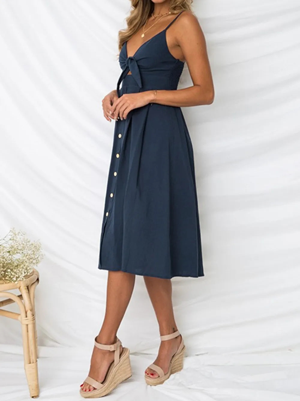 Cutout Smocked Sweetheart Neck Cami Dress with Decorative Button and Opaque Design, captured on a model in a side view, highlighting the elegant silhouette.