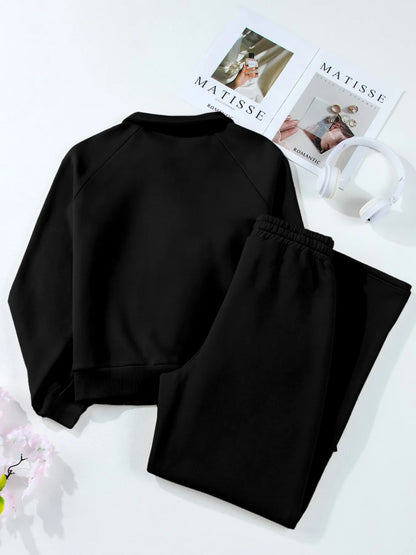 Back view of black Trendsi Collared Sweatshirt & High Waist Pants Two-Piece Active Set, displaying a cozy and stylish outfit arrangement.