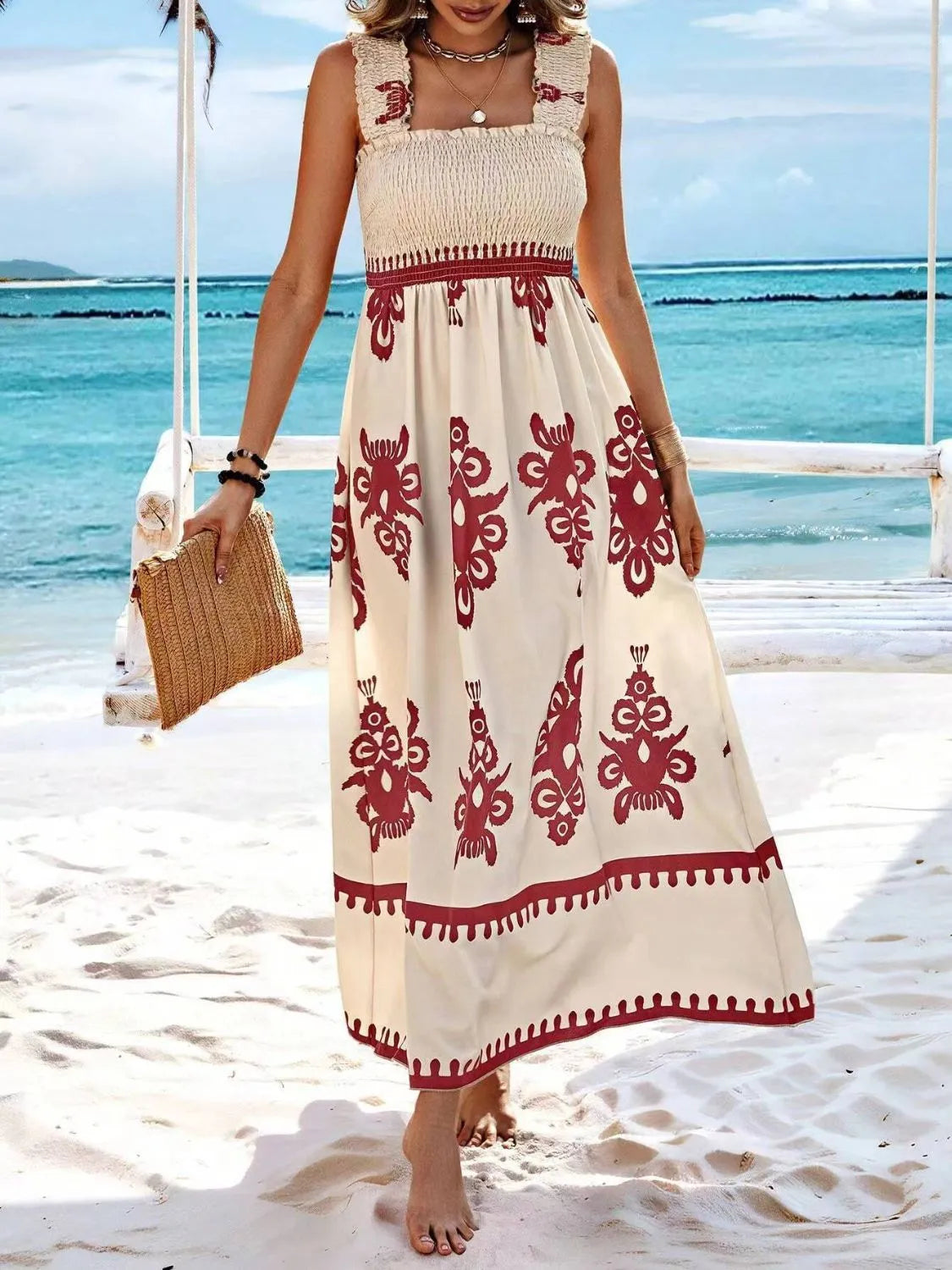 Trendsi Smocked Printed Maxi Dress with Wide Straps - Elegant Opaque, Non-Stretch Design, captured under the sun on the beach, featuring a stylish design.